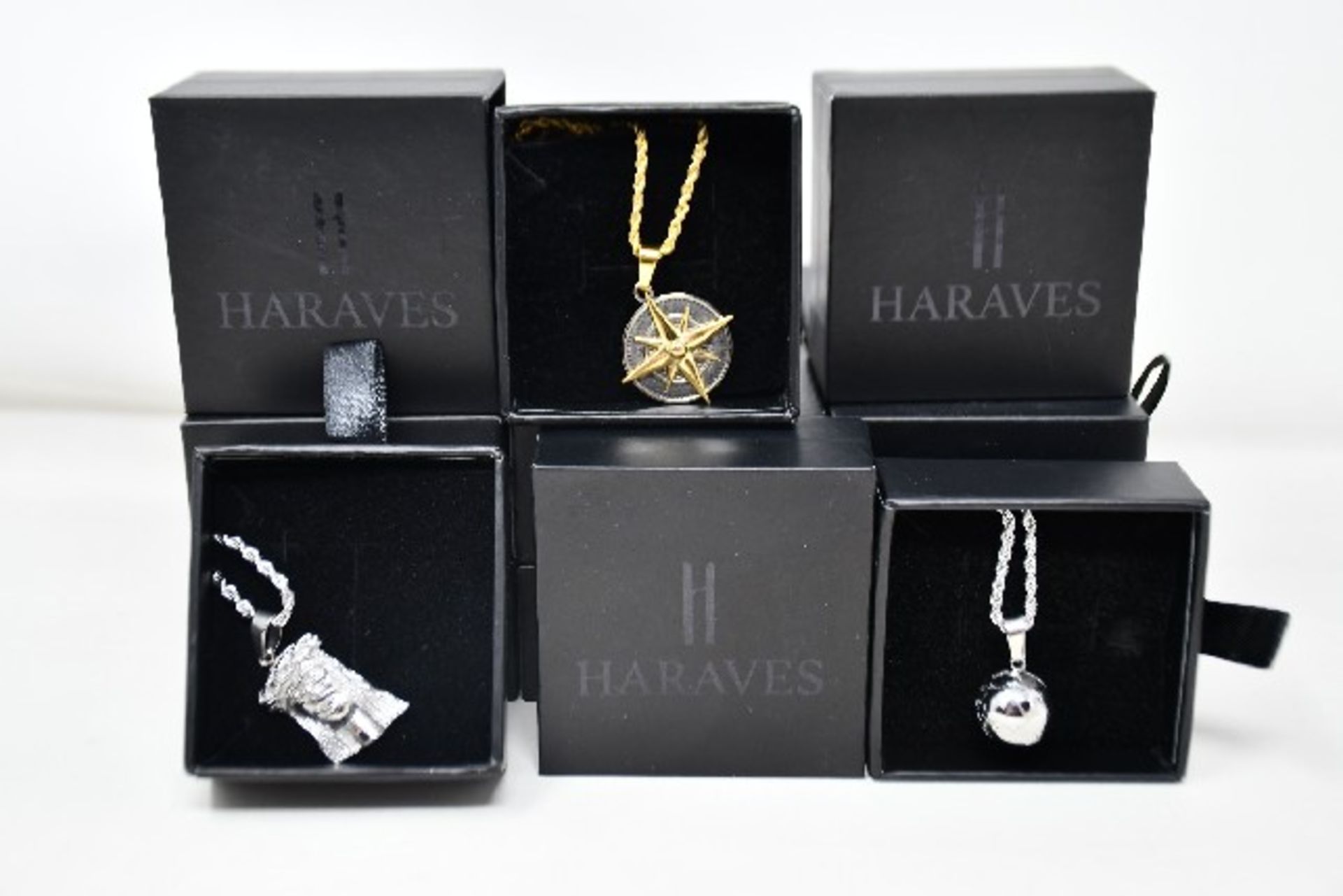 Fifteen items of assorted Haraves jewellery to include 5x Compass, 5x Globes and 5x Jesus.