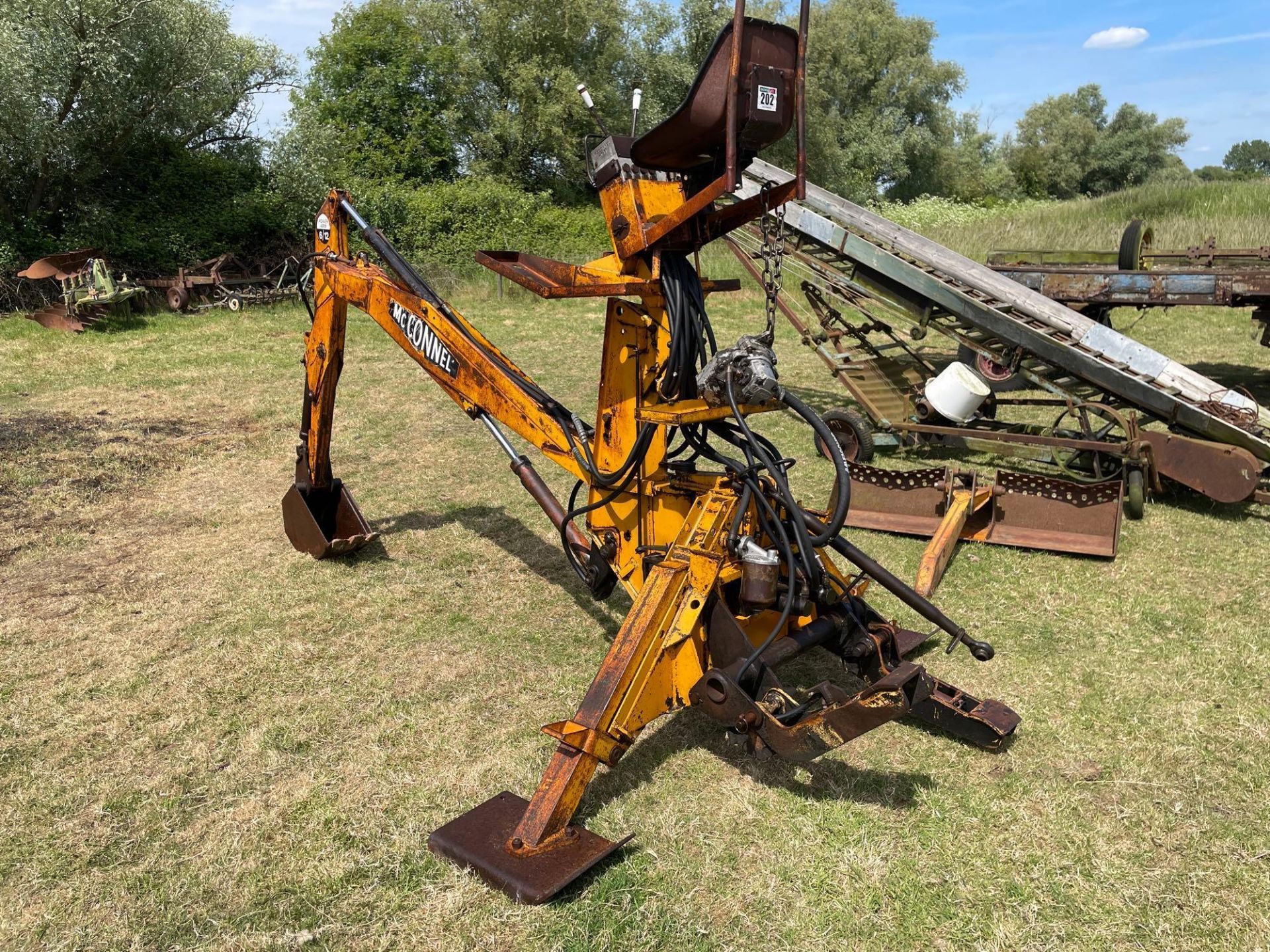 McConnel Powerarm 6/12 linkage mounted PTO driven backhoe with ditching and trenching bucket. Serial