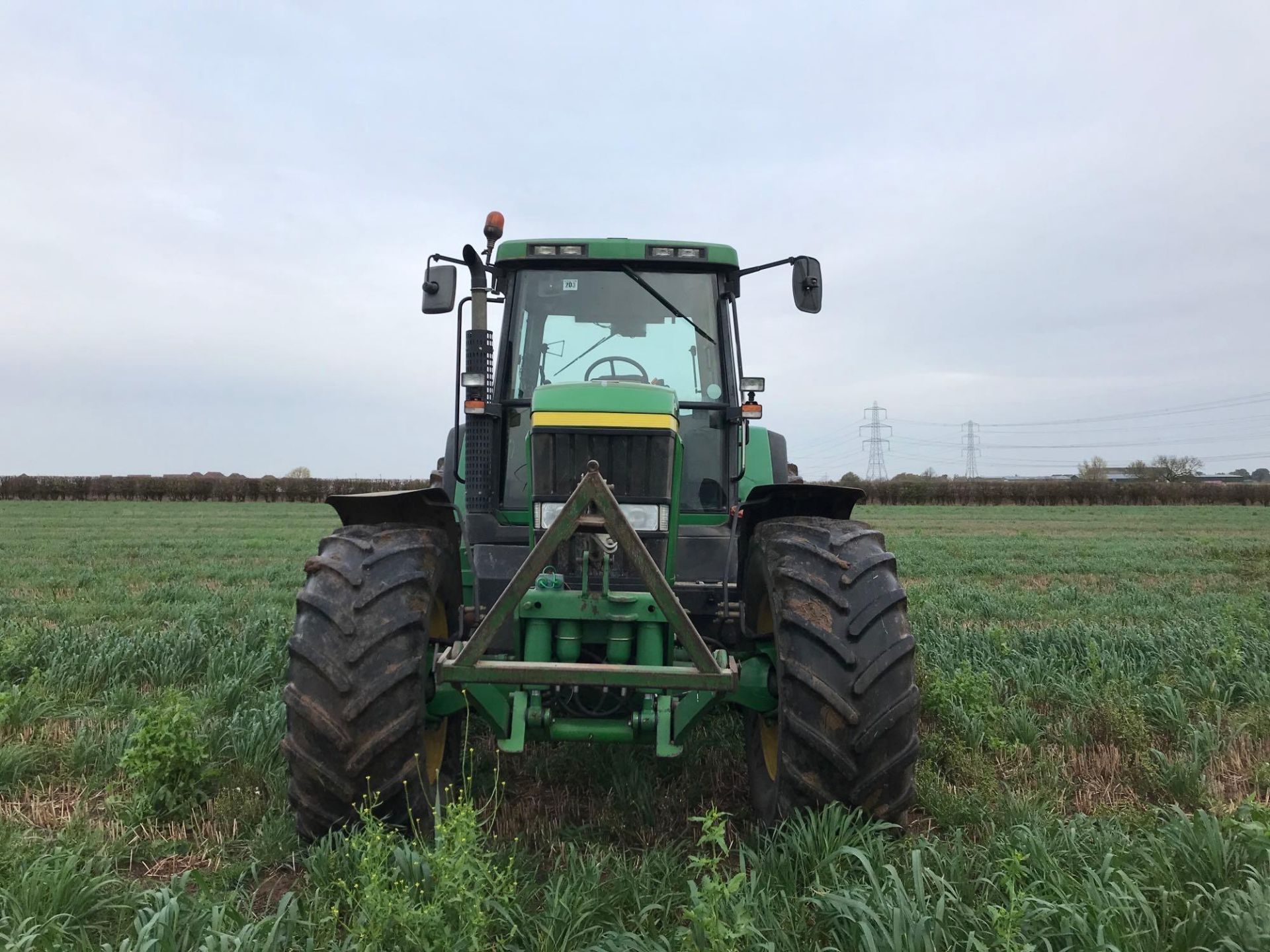 John Deere 7810 tractor with power quad gear box, 3 spool valves, pick up hitch, draw bar, air seat.