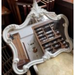 A white painted resin wall mirror with shaped plate, 61cmW