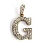 A 9ct gold 'G' pendant, set with white stones, approx. 6.6g