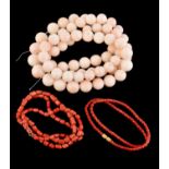 A coral bead necklace, the graduated circular coral beads with carved decoration measuring 1.7cm