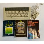 An Acorn Electron with power supply, user guide and programming books