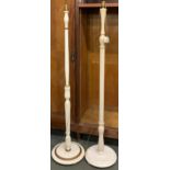 Two white painted standard lamps, the taller 155cmH