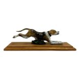 An painted bronze figure of a running foxhound, 20.5cmL
