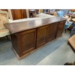 A 20th century oak low cupboard, moulded top over four panel doors, 188x46x65cmH