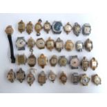 A collection of 34 wrist watches without straps to include Regency, Renova, Timex, Dulux, Mustang,