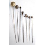 A collection of 21 hat pins to include two white metal in the form of acorns, a hallmarked silver