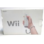 A boxed Nintendo Wii with one controller and nunchuk
