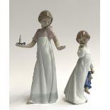 Two Nao by Lladro figurines, girl with candlestick and a young girl holding a doll, the tallest 26.