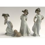 Three Nao by Lladro figurines, two girls in dresses together with a young girl with puppy, the