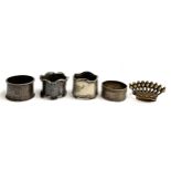 Two silver napkin rings (one af); together with two plated napkin rings and a brass napkin ring in
