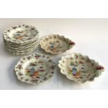 A set of 13 hand painted plates in Chinese style depicting floral arrangement, together with 2