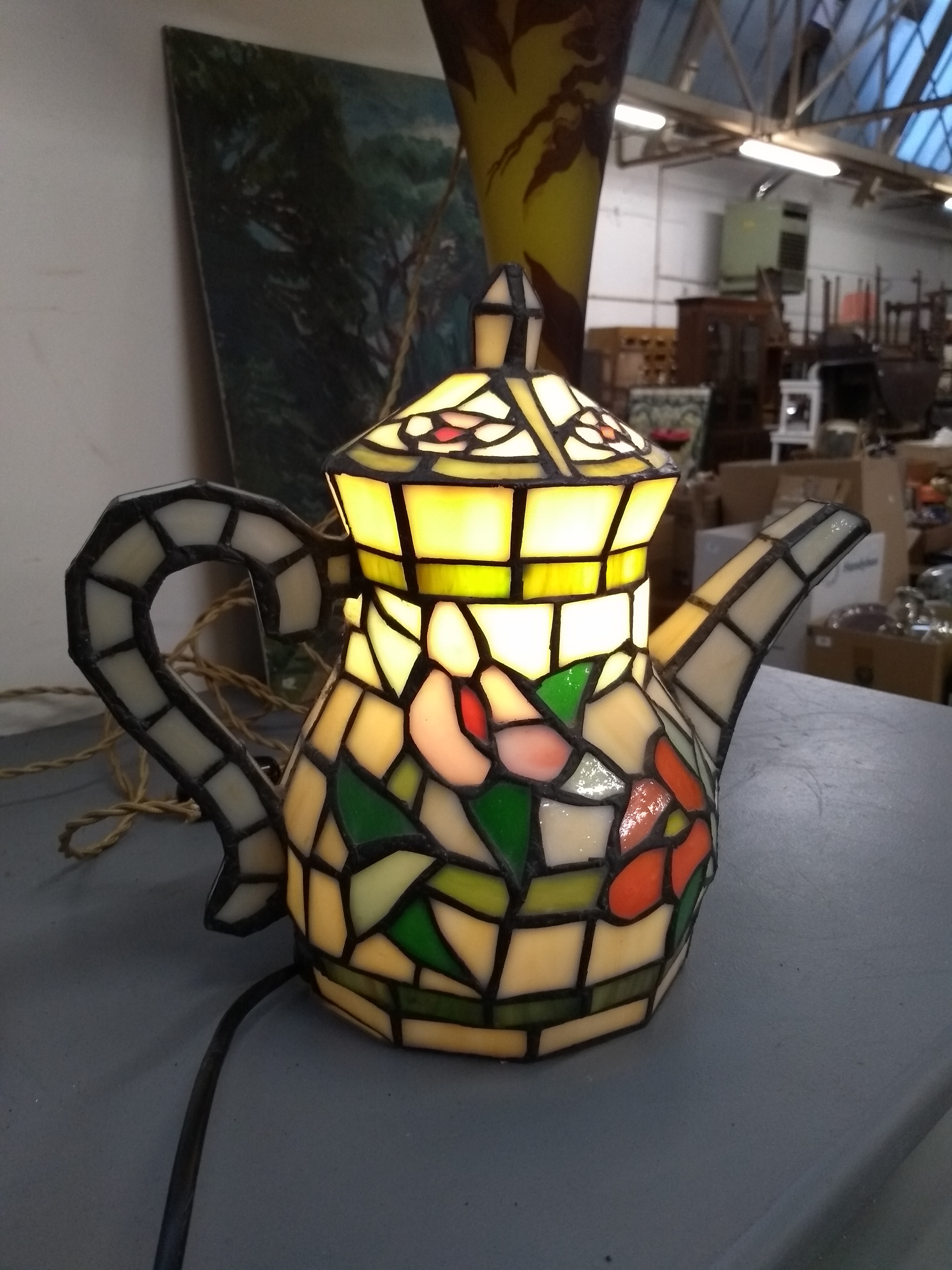 A stained glass lamp in the form of a teapot, 24cmH