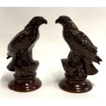 A pair of treacle glazed ceramic falcons, each 29cmH