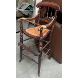 A Victorian spindle back caned child's highchair