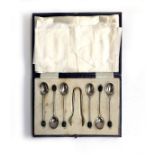 A cased set of six coffee bean terminal spoons, with sugar tongs, by Mappin & Webb, Sheffield 1928