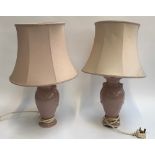 A pair of pink ceramic baluster form table lamps with shades