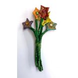A papier mache brooch by artist Julie Arkell, in the form of a bouquet of flowers, signed on