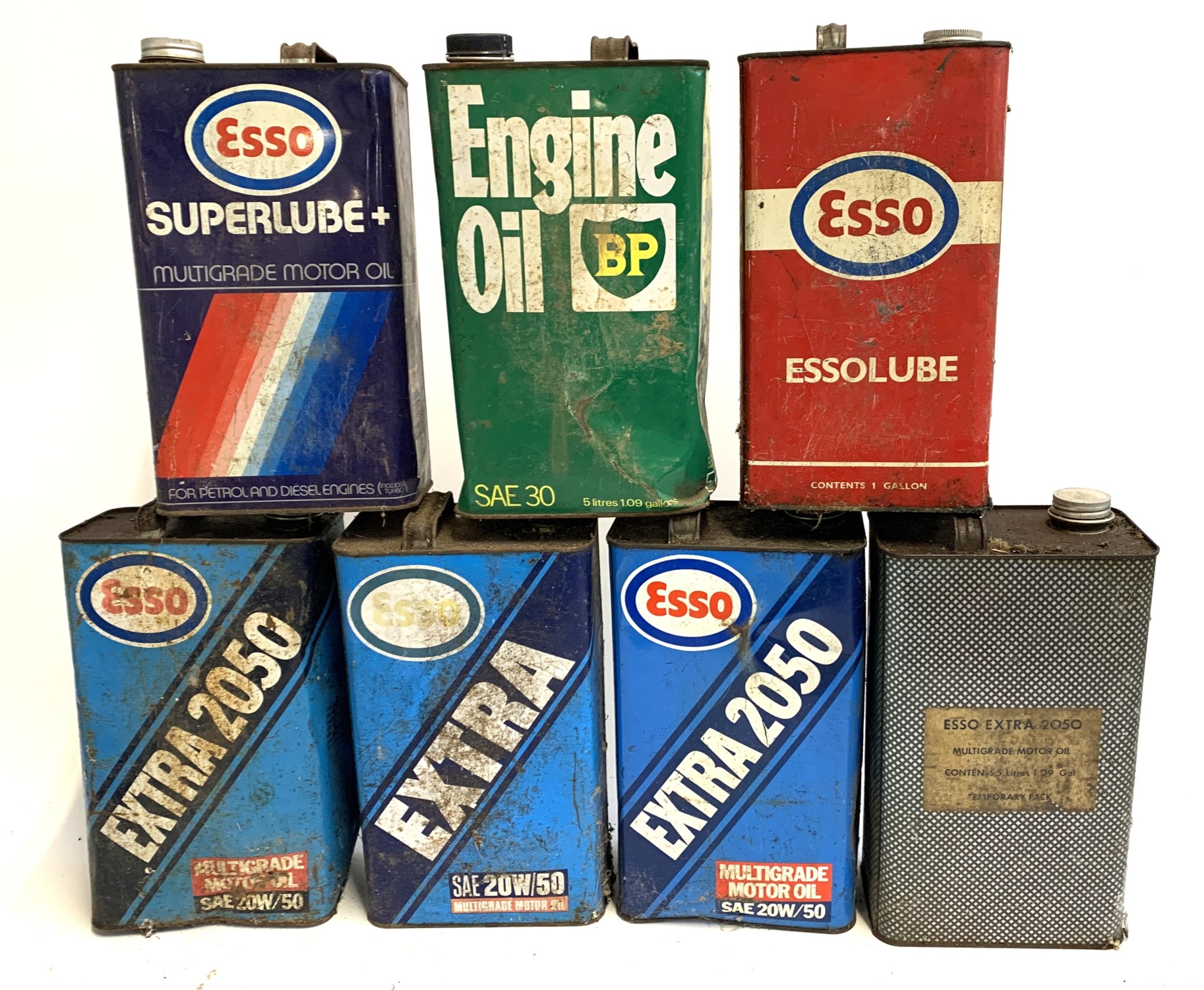 A lot of seven vintage oil cans, to include Esso Superlube; Essolube; BP Engine Oil; Esso Extra