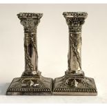 A pair of Sheffield plate candlesticks by Walker & Hall in the form of columns with Corinthian