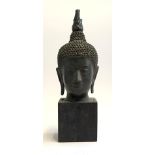 A bronze bust of Buddha on square hardwood plinth, purchase in Hong Kong 1978, 39cmH