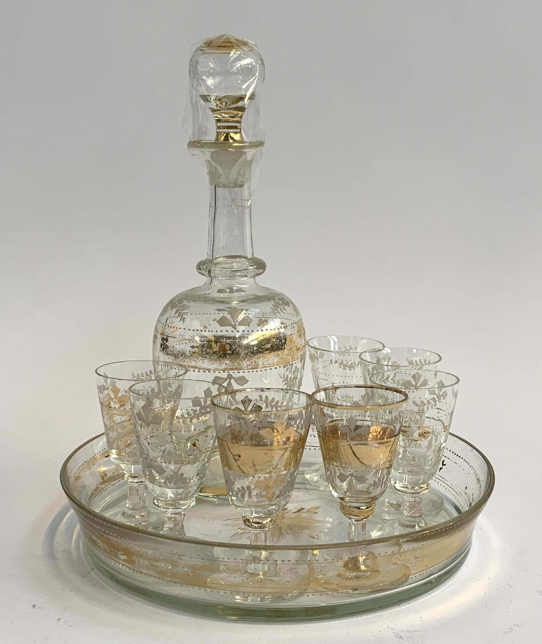 A Bohemian glass gilt schnapps decanter set, comprising decanter, seven stemmed glasses, and