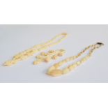 A mother of pearl graduated bead necklace with barrel clasp, 50cmL; together with a carved bone