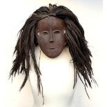 An African tribal mask with rush hair, the face 19cmL