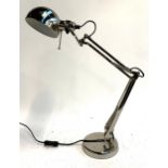 An adjustable chrome desk lamp