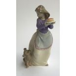 A Nao figure of a girl with puppy and cake, 19cmH