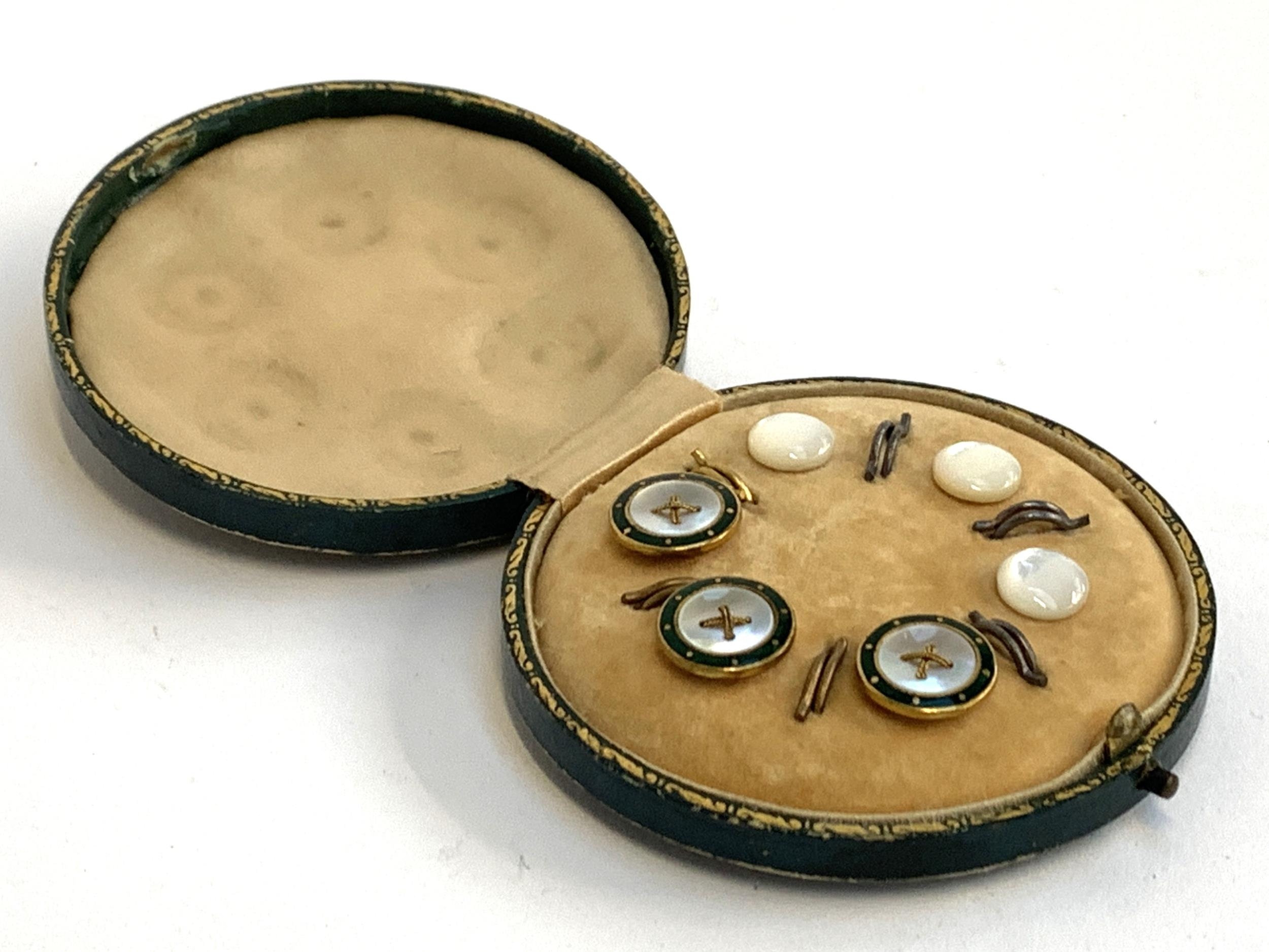 A cased set of mother of pearl and enamel studs