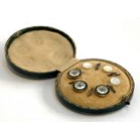 A cased set of mother of pearl and enamel studs
