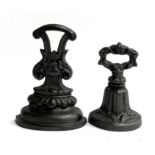 Two cast iron doorstops, 23cmH and 18.5cmH