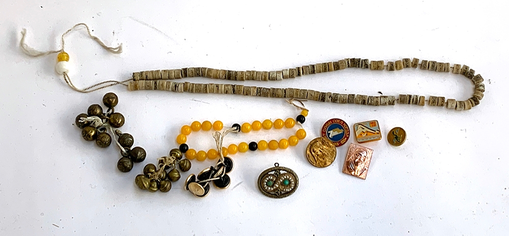 A mixed lot to include bone rosary beads, various other beads, modern Mongolian enamel badges and