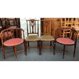 A matched pair of Edwardian mahogany occasional chairs, with oval seats on turned tapering legs;