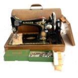 A Singer sewing machine, model number EH981974, in domed wooden carry case, together with a box of