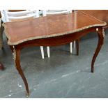 A shaped ormolu mounted occasional table, shaped top over apron, on slender cabriole legs,