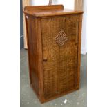 A 20th century small oak shoe cupboard, the door with applied scrolling motif, 42x33x76cmH