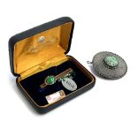 A sterling silver pendant/brooch set with a central pierced jade lozenge, 4.5cmD; together with a