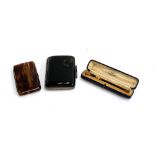 A tortoiseshell and yellow metal mounted cheroot holder in leather case, together with a silver