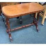 A very small 19th century mahogany writing table, on turned supports, joined by a turned stretcher