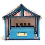 A scratch built miniature fairground stall of 4 targets with 4 miniature guns within a pin stripe