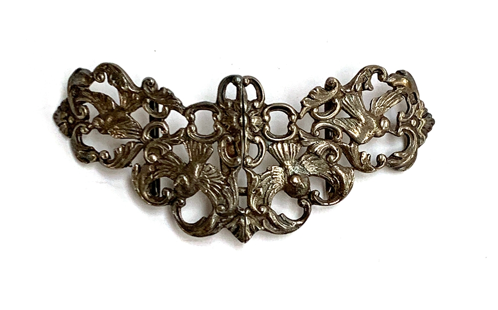 An early 20th century silver nurses buckle with pierced dove design, hallmarked Samuel Jacob,