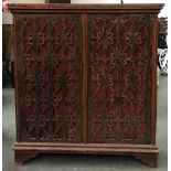 A narrow cupboard with three shelves, with pierced fabric lined doors, 115x27124cmH