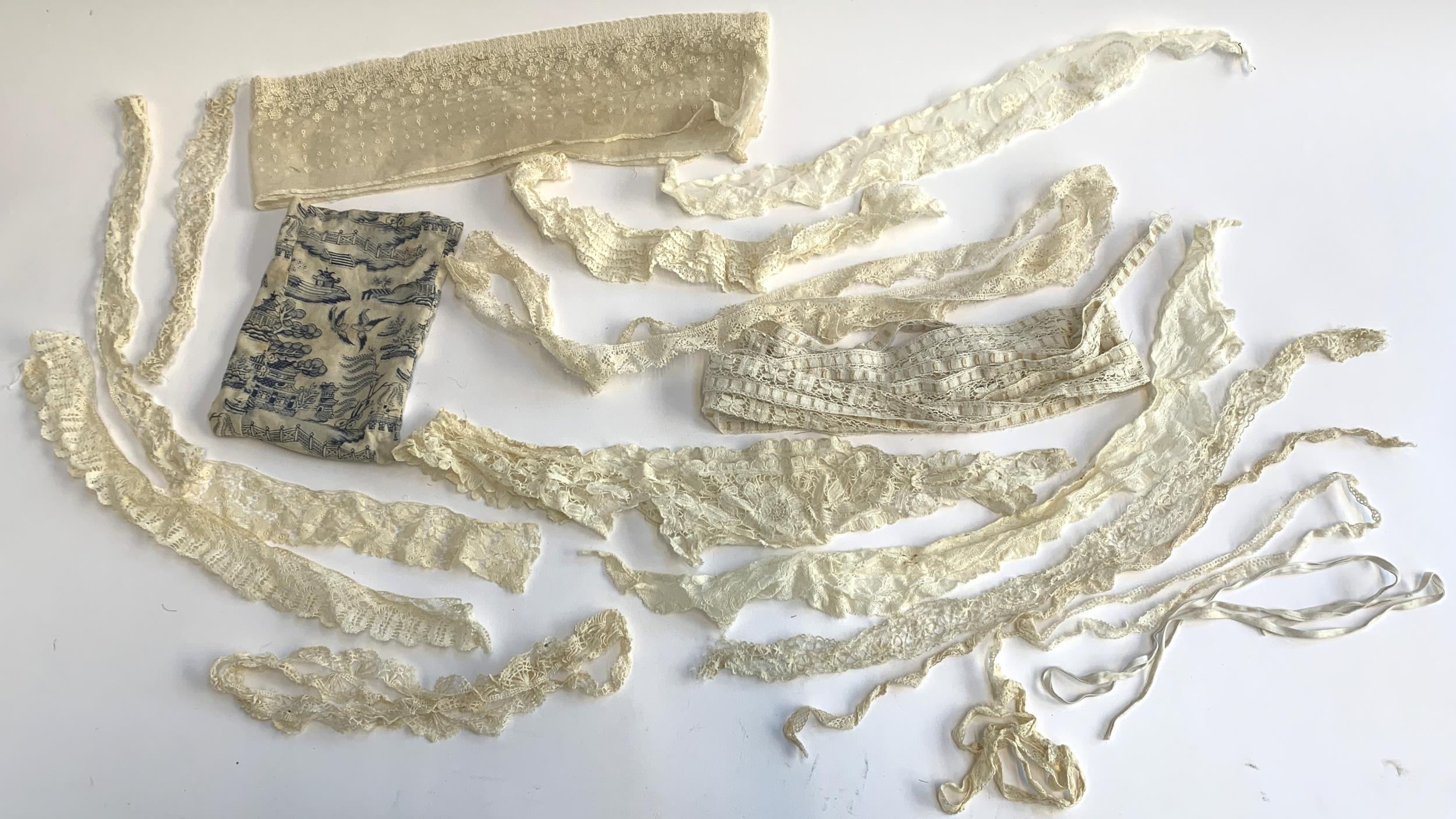 A quantity of fine antique lace trim; together with a fabric Willow pattern pouch