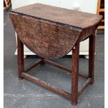 An early 20th century small oak dropleaf occasional, table in the form of a joint stool, with