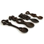 Four provincial carved wooden love spoons, the largest 23cmL