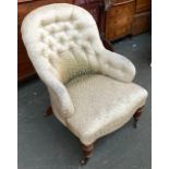 A Victorian buttonback armchair, with serpentine seat, on turned legs and brass casters