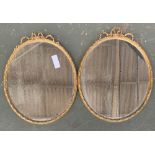 A pair of oval gilt gesso framed wall mirror with ribbon cresting, 64x50